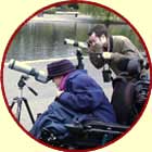 Two people spotting wildlife through telescopes in St James' Park